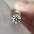 Round hearts and arrows moissanite in daylight - Caratura