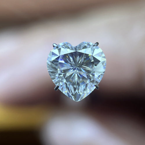 Heart moissanite loose stone held face-up in a prong holder, D colour VVS clarity — Caratura