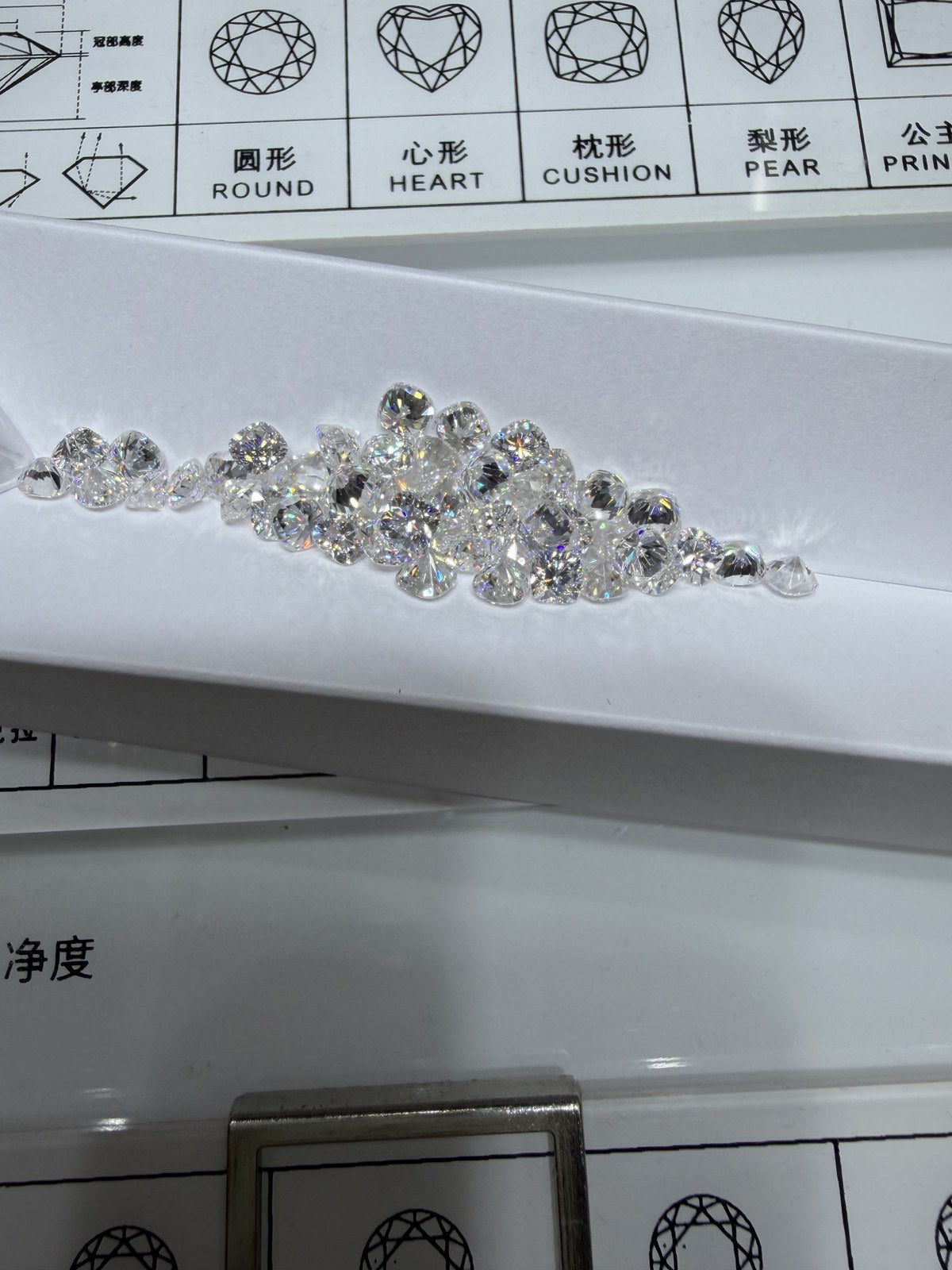Cushion lab-grown diamond melee, DE VS-VVS, on an inspection tray