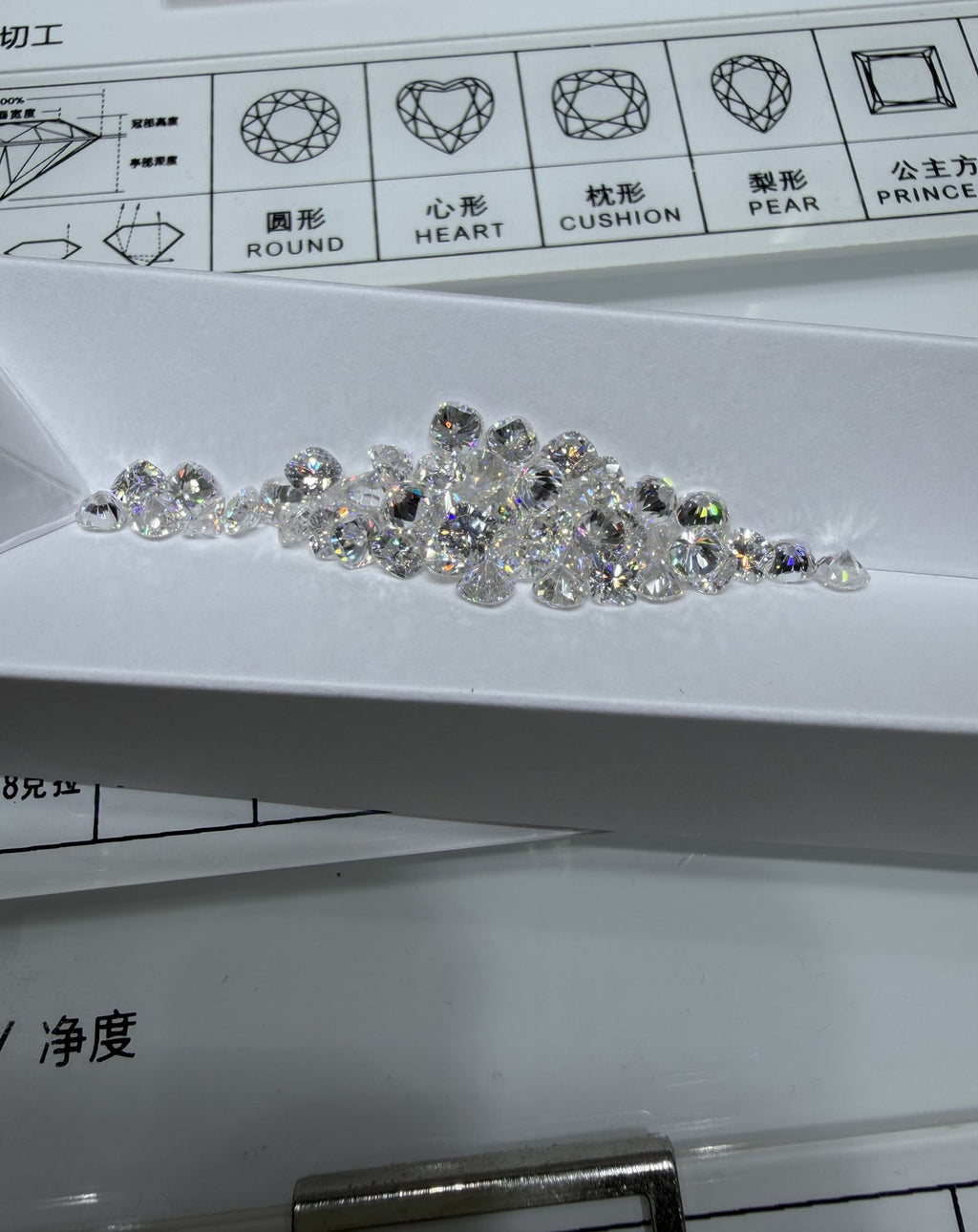 Cushion lab-grown diamond melee, DE VS-VVS, on an inspection tray