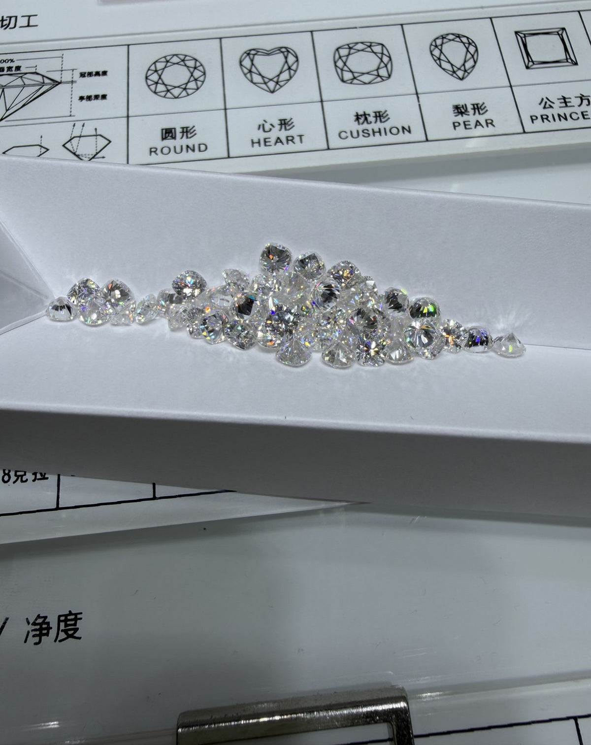 Cushion lab-grown diamond melee, DE VS-VVS, on an inspection tray