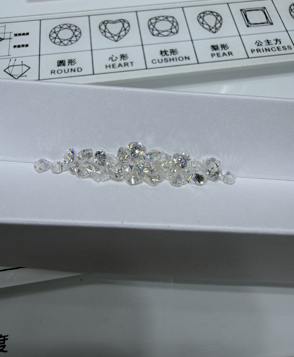 Heart lab-grown diamond melee, DE VS-VVS, on an inspection tray