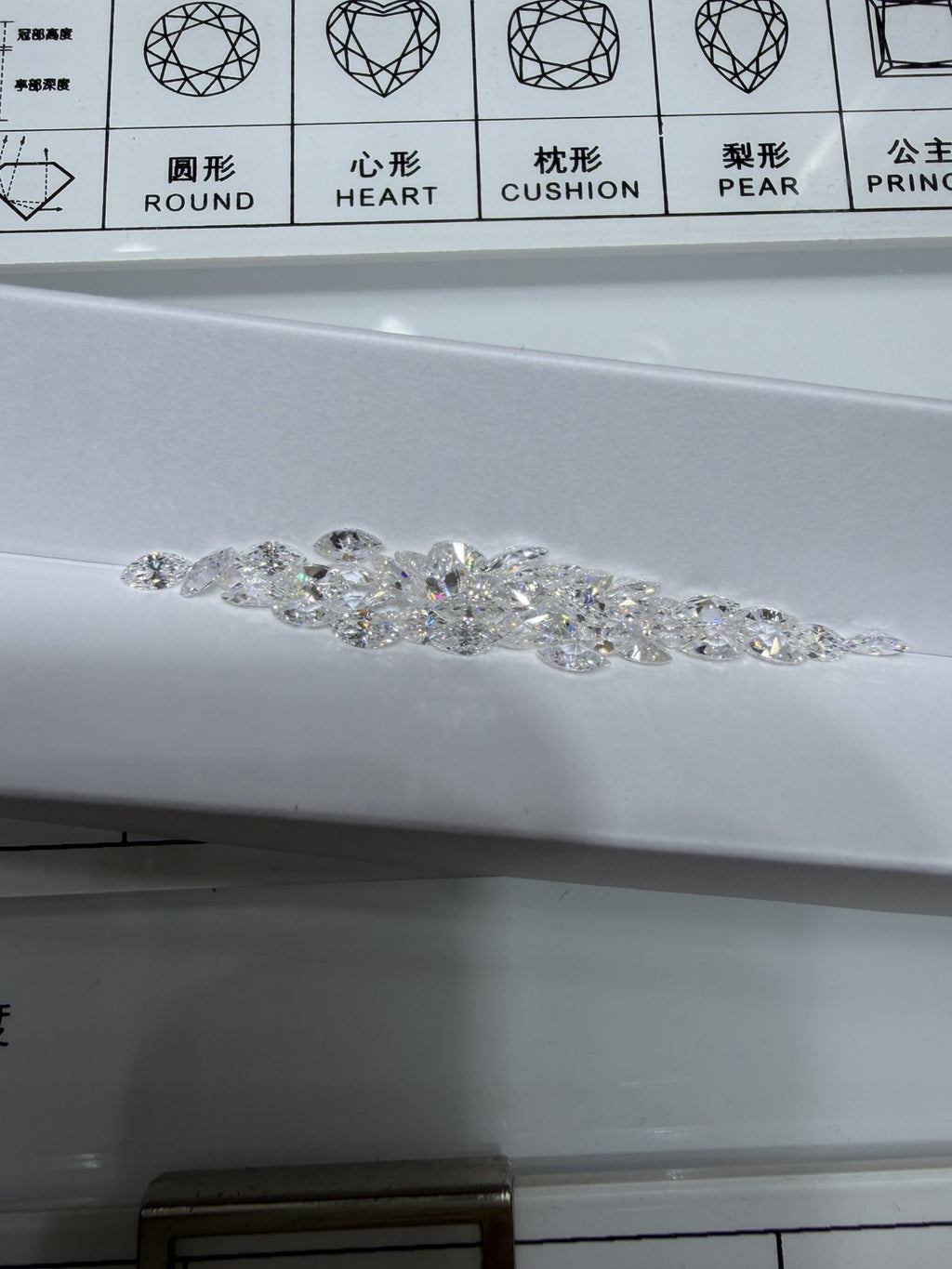 Marquise lab-grown diamond melee, DE VS-VVS, on an inspection tray