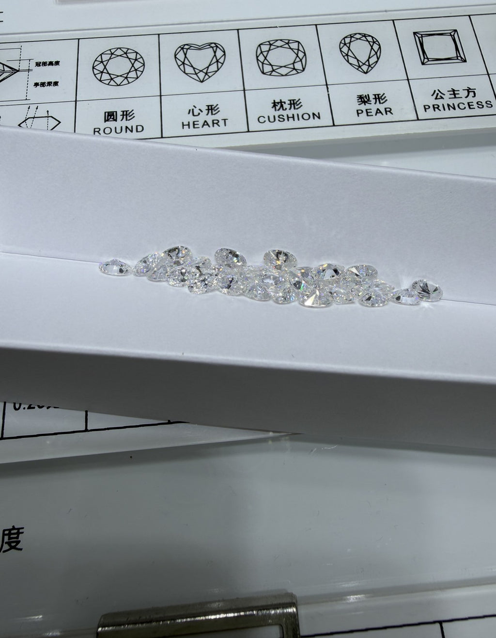Oval lab-grown diamond melee, DE VS-VVS, on an inspection tray