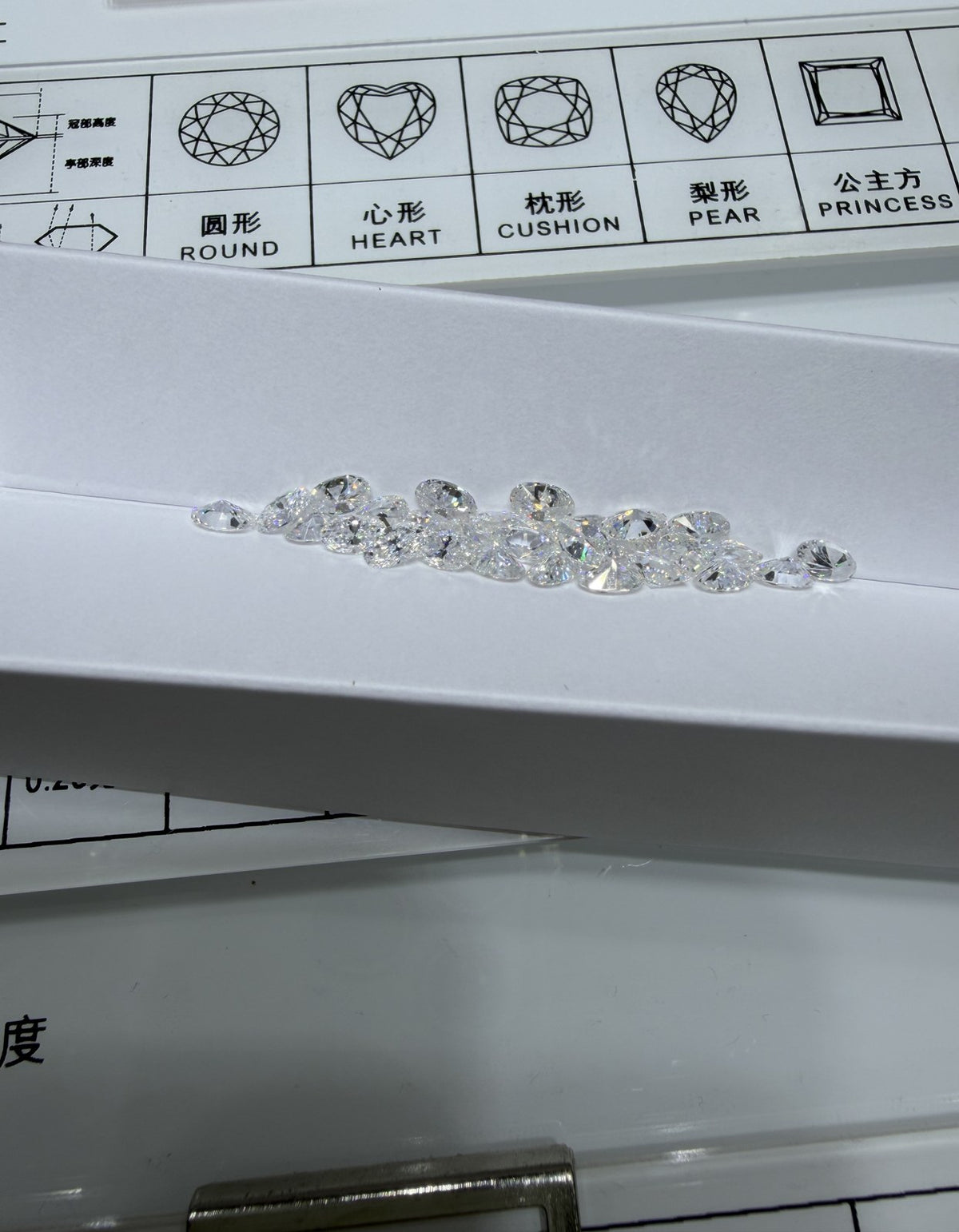 Oval lab-grown diamond melee, DE VS-VVS, on an inspection tray
