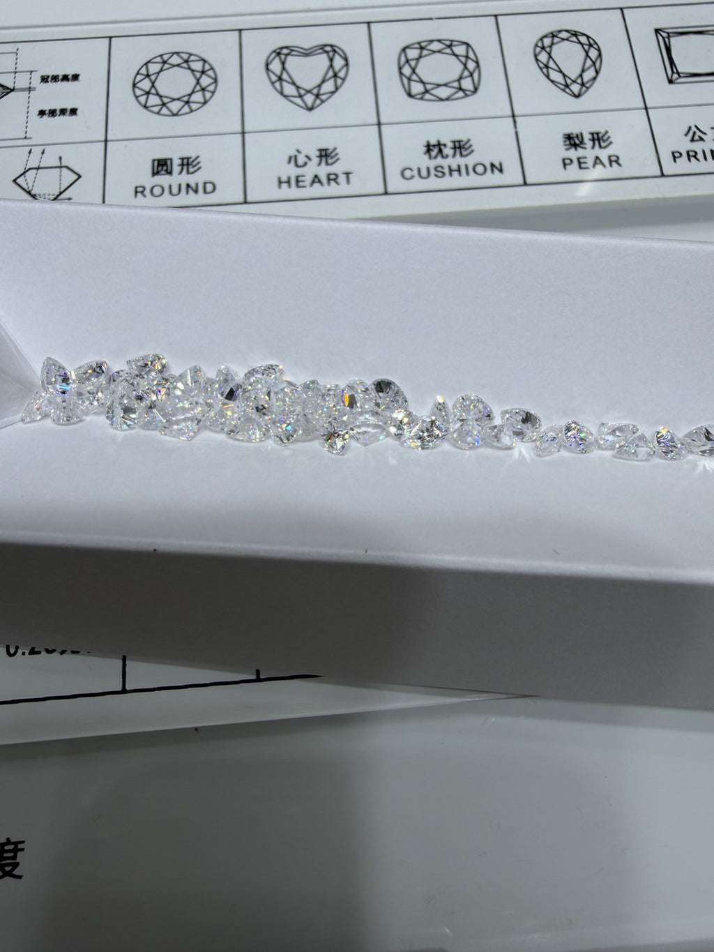 Pear lab-grown diamond melee, DE VS-VVS, on an inspection tray