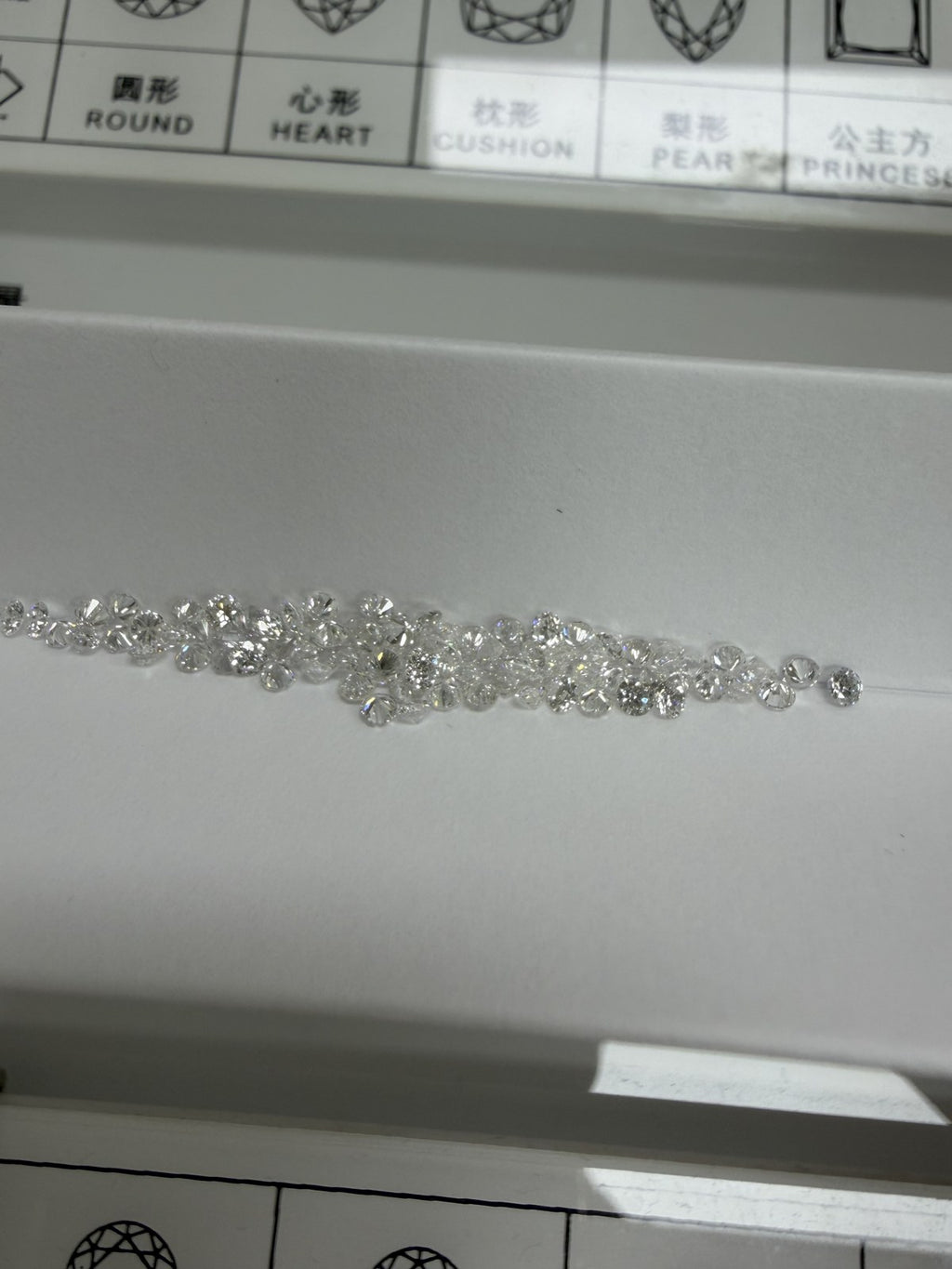 Round lab-grown diamond melee, DE VS-VVS, on an inspection tray