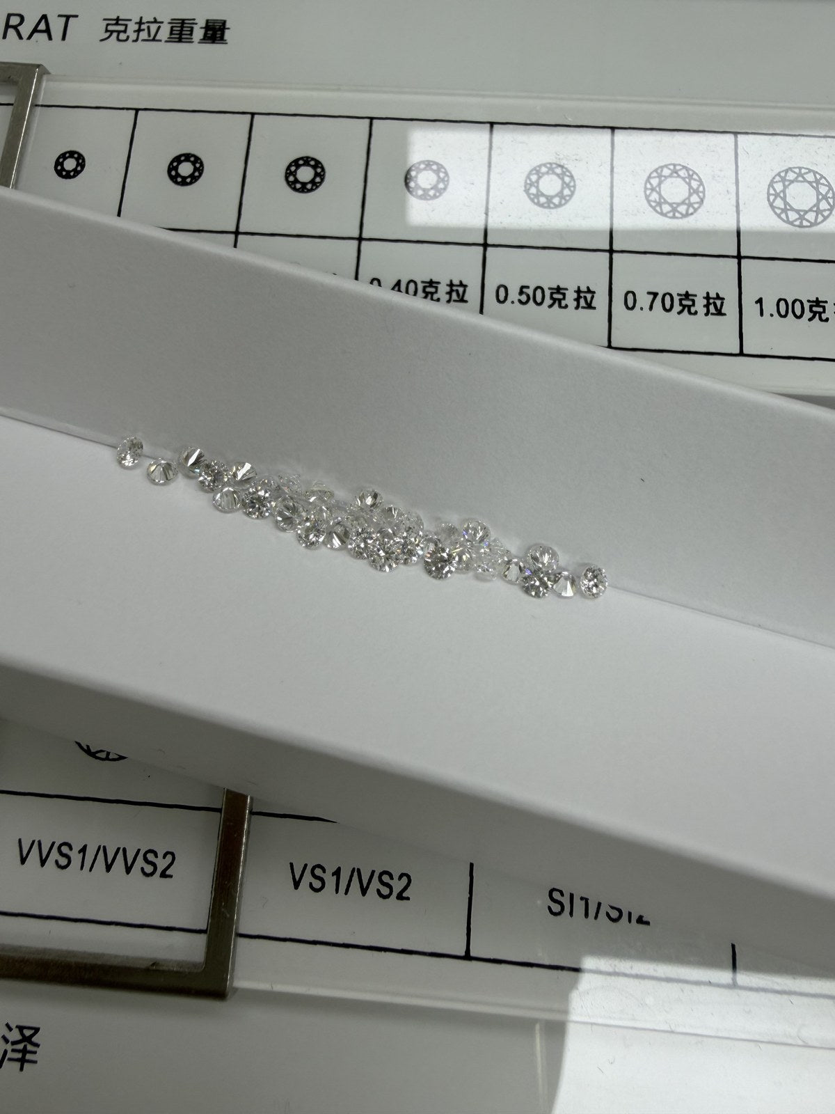 Round lab-grown diamond melee, DE VS-VVS, on an inspection tray