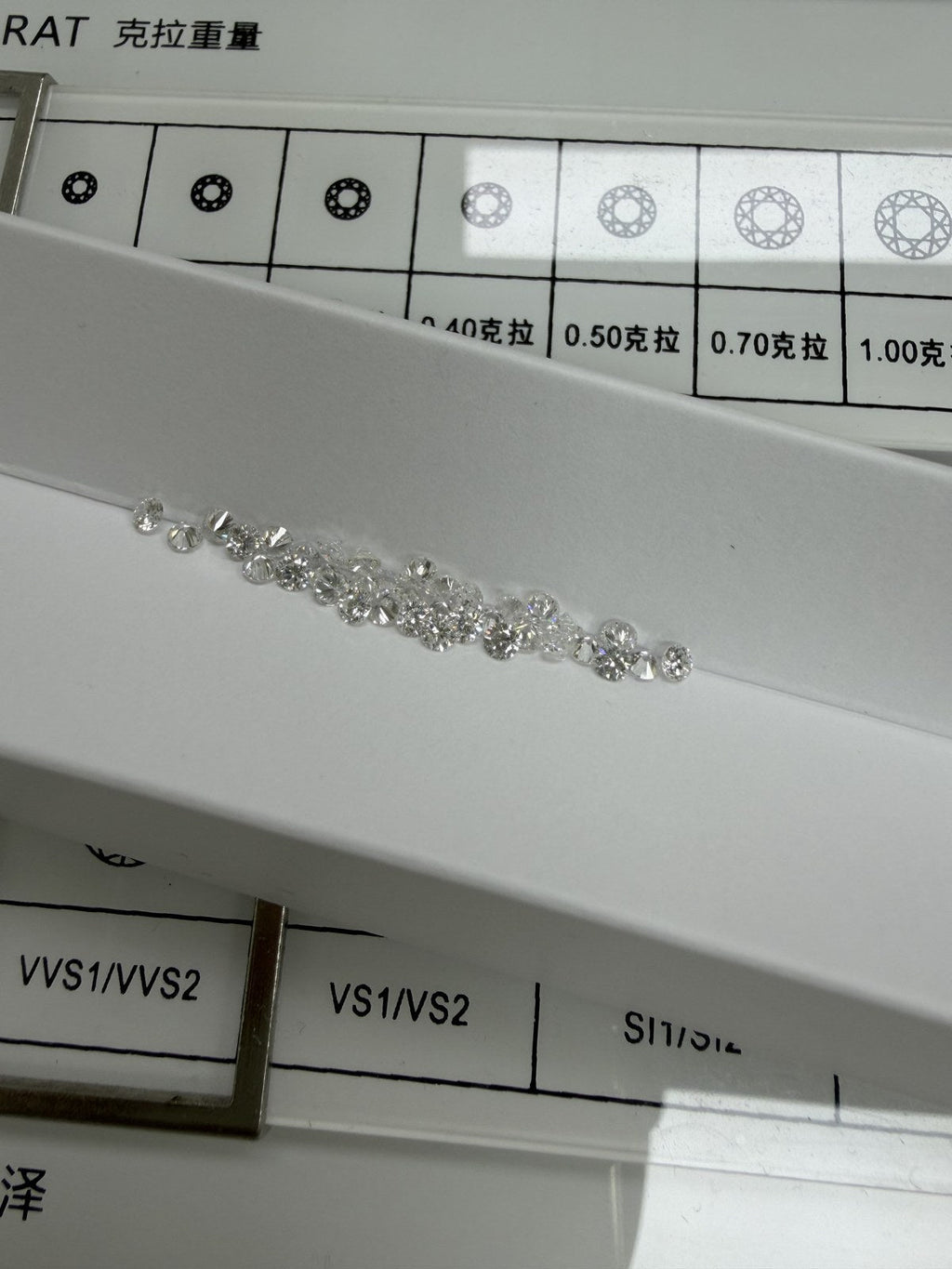 Round lab-grown diamonds, DE VS-VVS, on an inspection tray